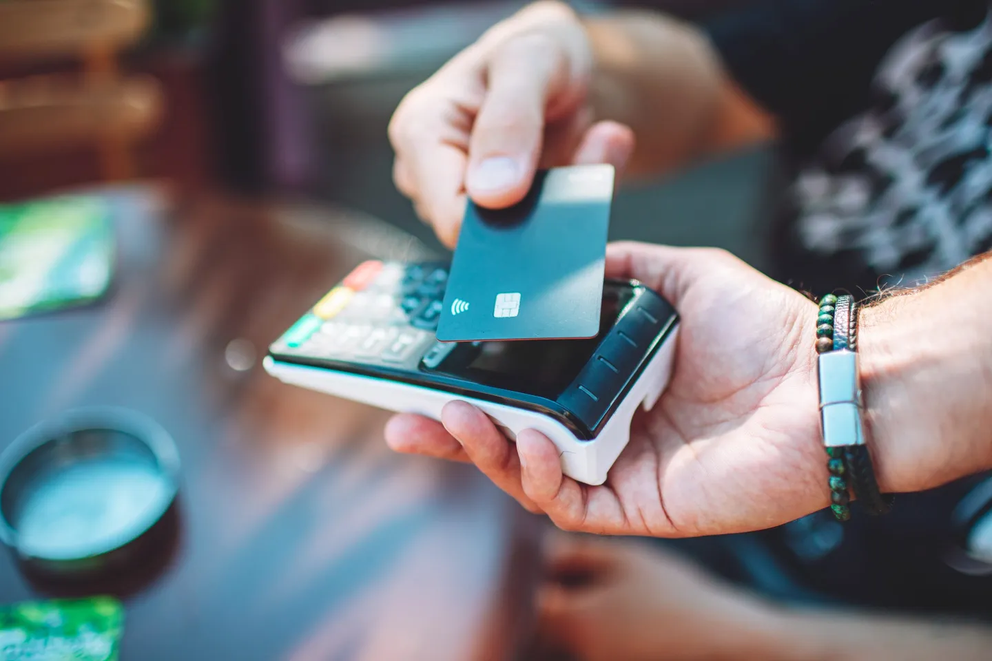 Person taps to pay using a credit card