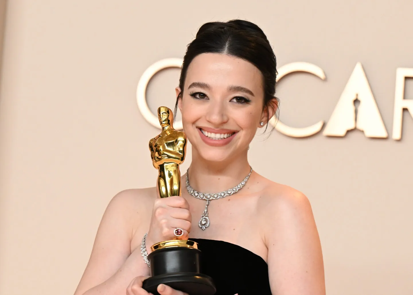 Mikey Madison holding an Oscar